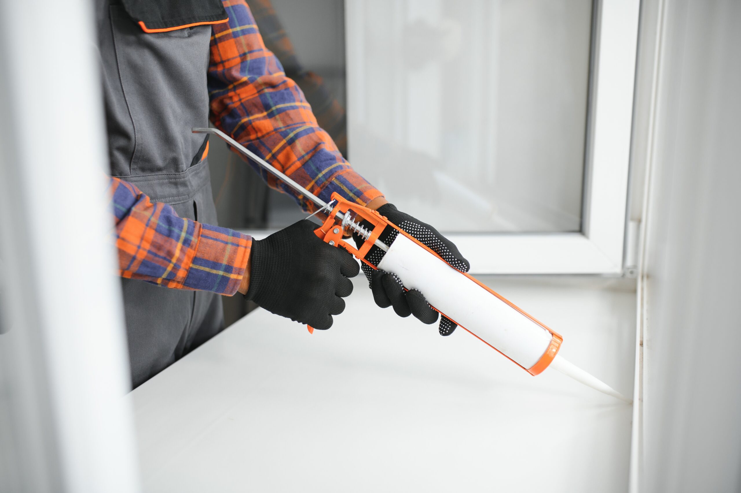 African service man installing window Reliaco Painting Fishers, IN