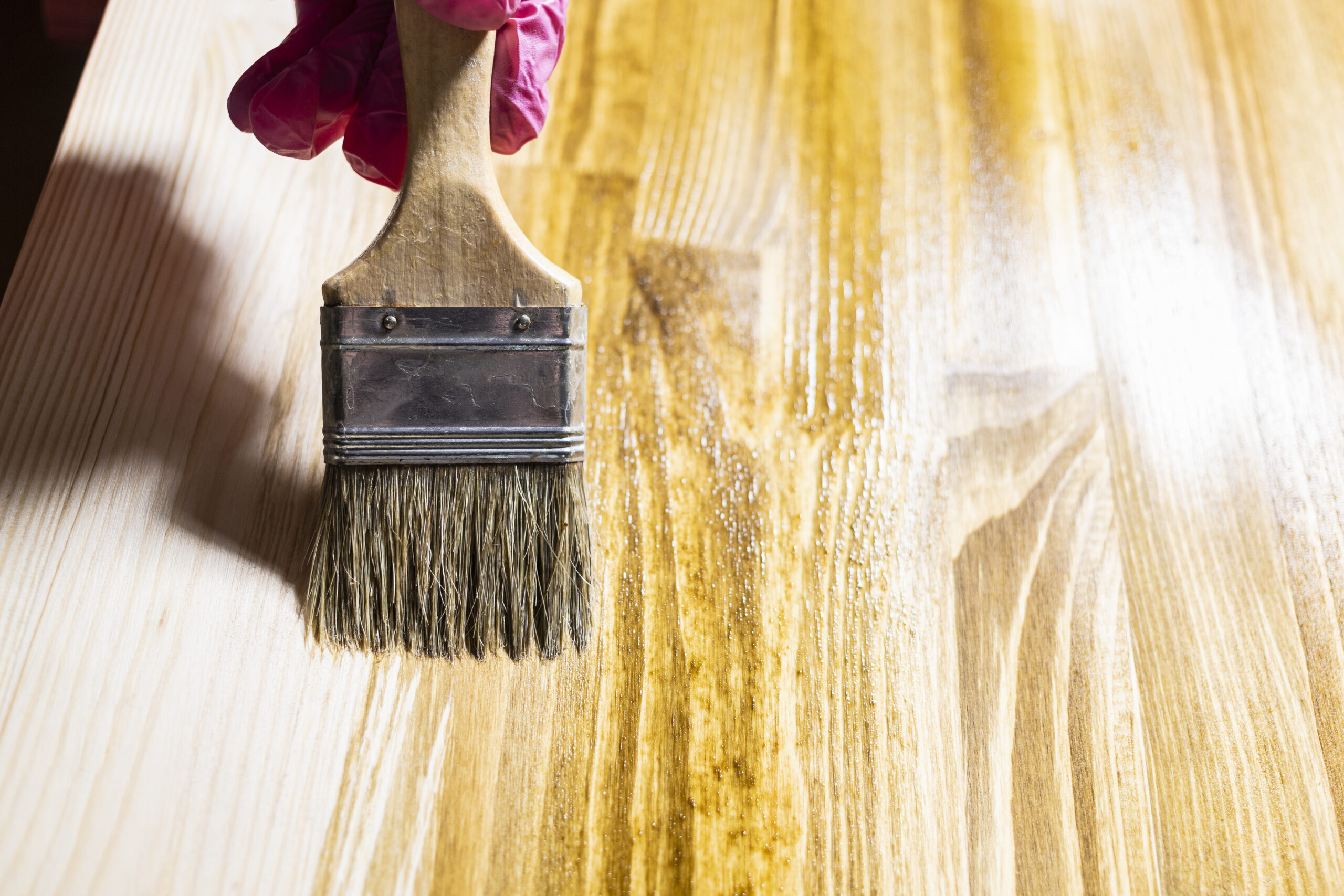 wooden board is covered with wood stain close up Reliaco Painting Fishers, IN